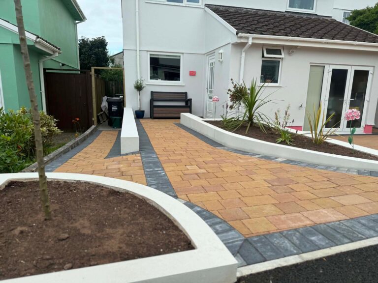 Completed block paved driveway in Harvest colour with ACO drainage and retaining walls installed by ESSA Building Solutions
